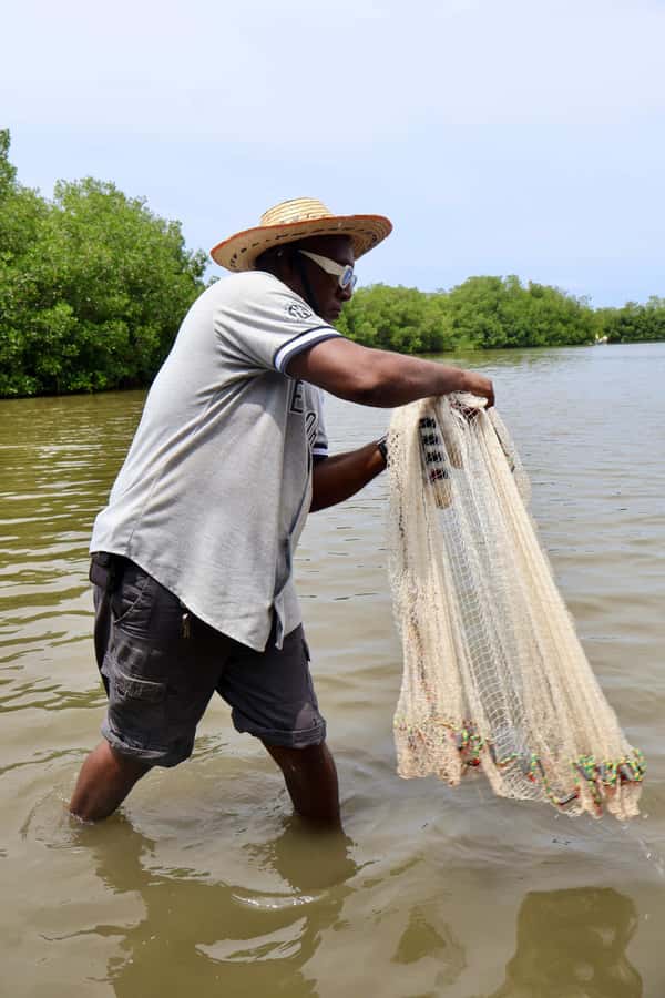 Typical lunch on beach, mangrove tour & fishing with natives - Casting nets and setting crab pots